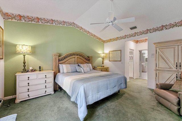 bedroom featuring visible vents, ensuite bathroom, ceiling fan, vaulted ceiling, and carpet flooring