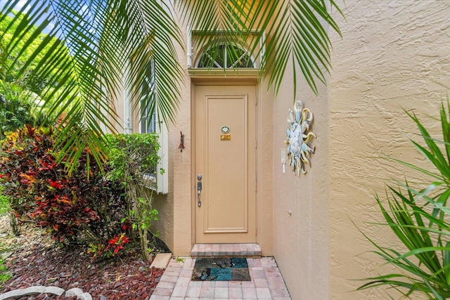property entrance featuring stucco siding