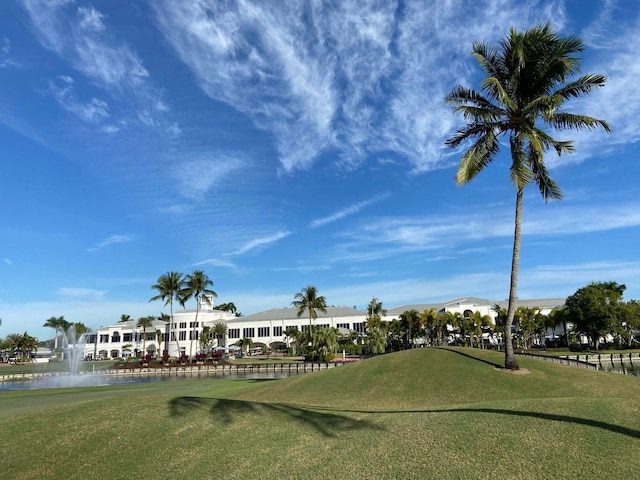 view of home's community with a water view, a residential view, and view of golf course