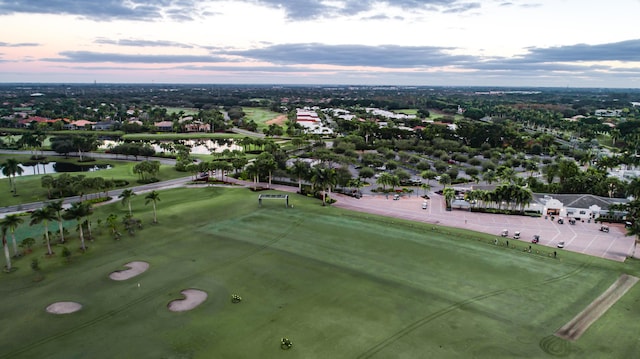 aerial view at dusk featuring a residential view and a water view