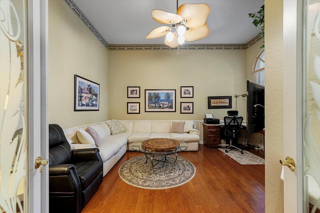 living room with a ceiling fan and wood finished floors