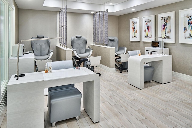 home office with a tray ceiling, baseboards, recessed lighting, and wood finished floors