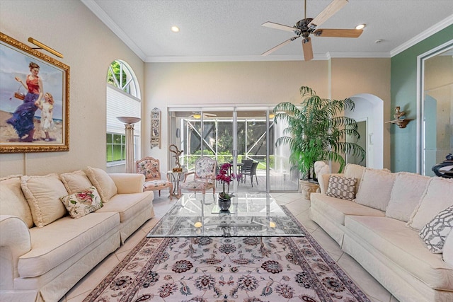 tiled living room with arched walkways, a textured ceiling, ornamental molding, a ceiling fan, and recessed lighting