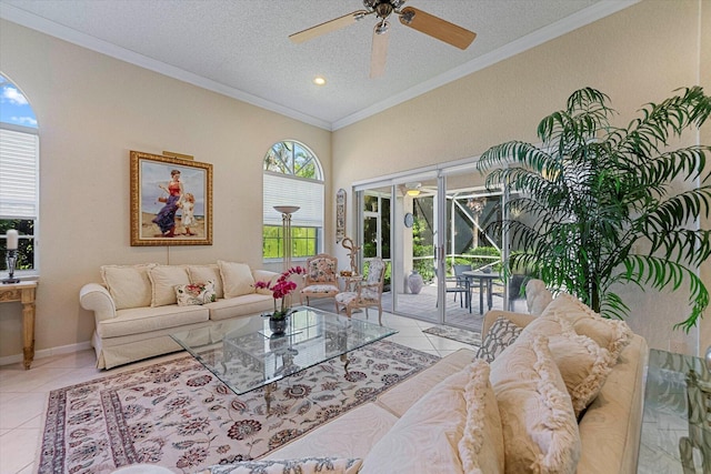 living area with light tile patterned floors, a textured ceiling, ornamental molding, and ceiling fan