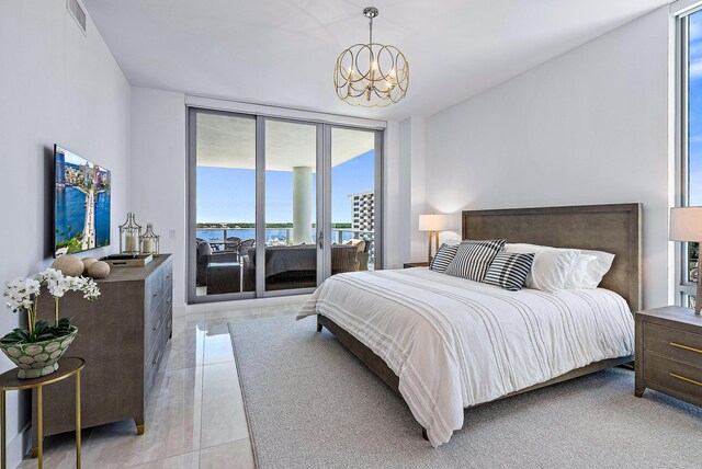 bedroom featuring expansive windows, access to outside, and an inviting chandelier