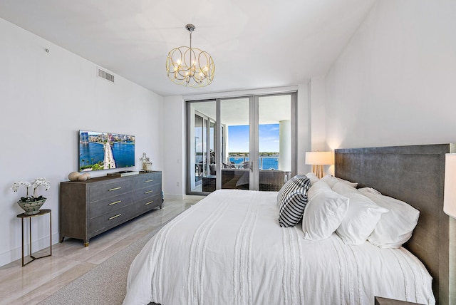 bedroom with expansive windows, access to outside, and a notable chandelier