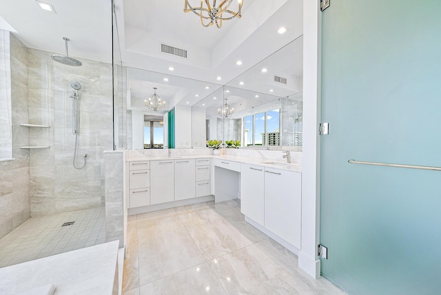 bathroom featuring vanity, an enclosed shower, and a chandelier