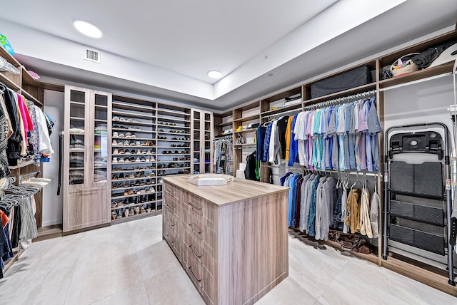 walk in closet with light tile patterned flooring