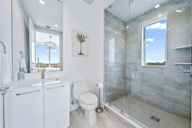 bathroom with an enclosed shower, vanity, toilet, and a wealth of natural light