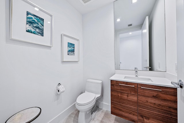 bathroom with toilet and vanity