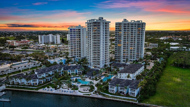 aerial view at dusk featuring a water view