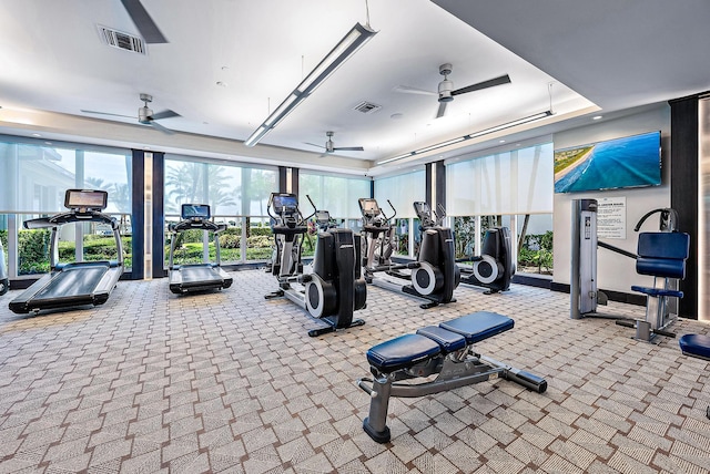 exercise room with light colored carpet and ceiling fan