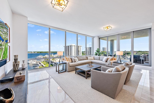 living room featuring a water view, a healthy amount of sunlight, and expansive windows