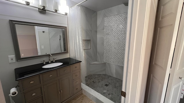 bathroom featuring vanity, a shower with curtain, and tile patterned floors