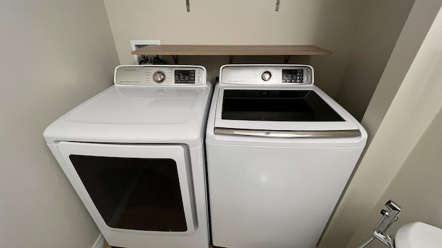 laundry area featuring washing machine and clothes dryer