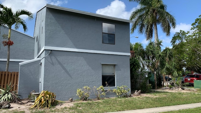 view of side of home with a lawn