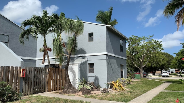 view of side of home featuring a lawn