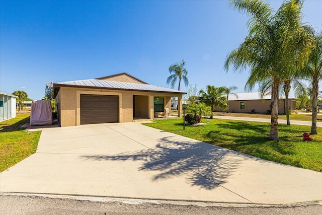 ranch-style home featuring a garage and a front lawn