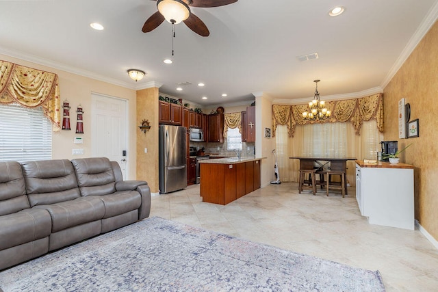 living room with ceiling fan with notable chandelier, light tile floors, and crown molding