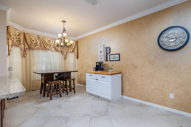 dining room featuring ornamental molding, a notable chandelier, and light tile flooring