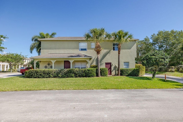 mediterranean / spanish-style house featuring a front lawn