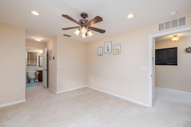 empty room featuring light colored carpet and ceiling fan