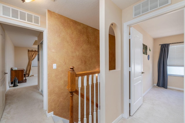 corridor with light colored carpet