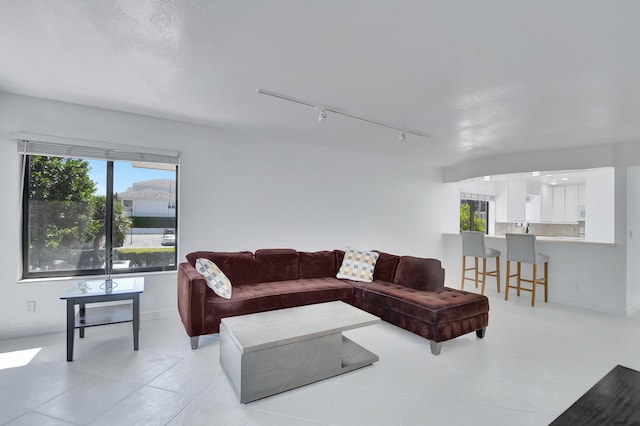 tiled living room with rail lighting