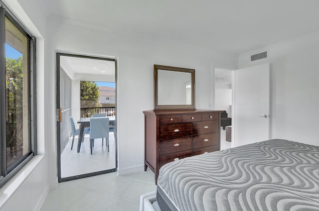 bedroom with light tile flooring and access to outside