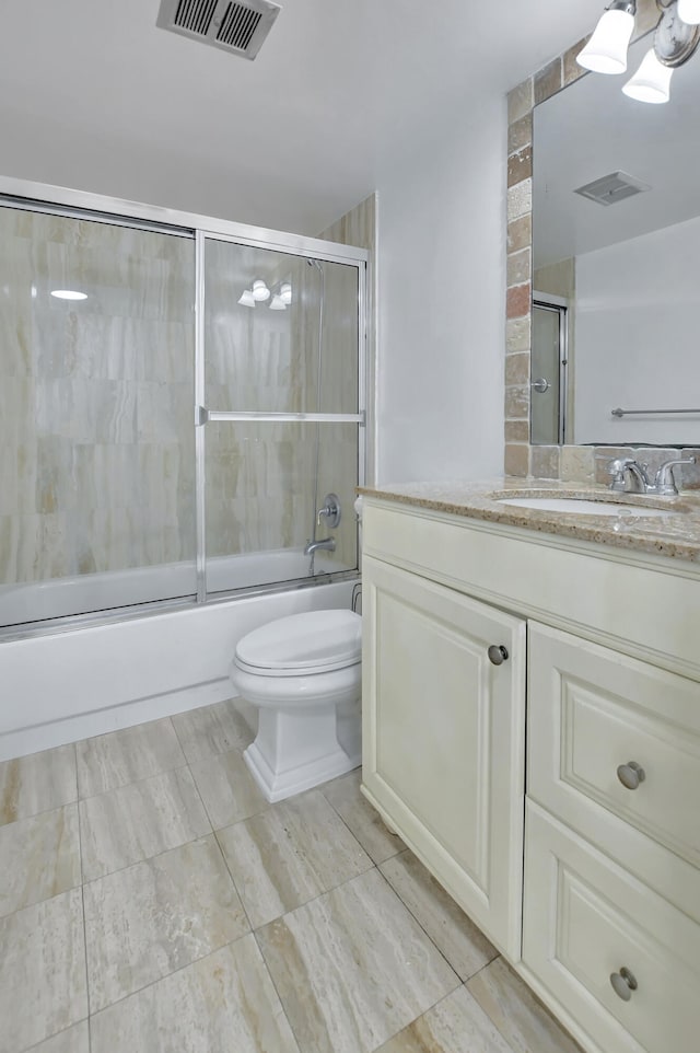 full bathroom featuring enclosed tub / shower combo, toilet, tile flooring, and large vanity