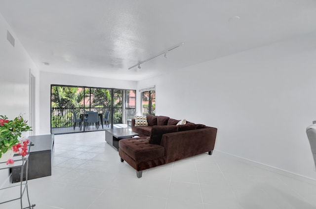 tiled living room with rail lighting