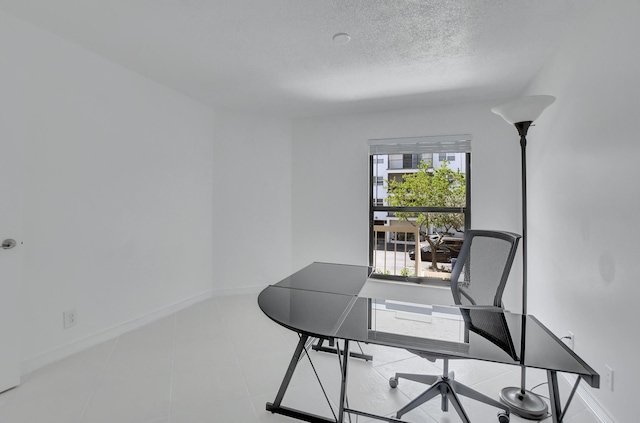 office featuring a textured ceiling and light tile floors