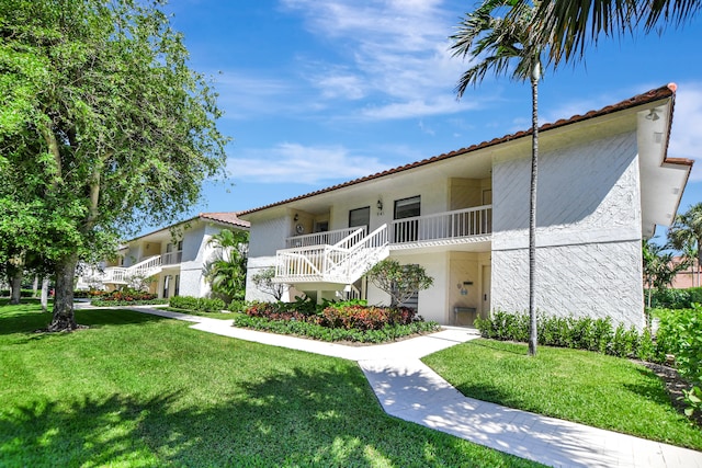 mediterranean / spanish-style house featuring a front yard