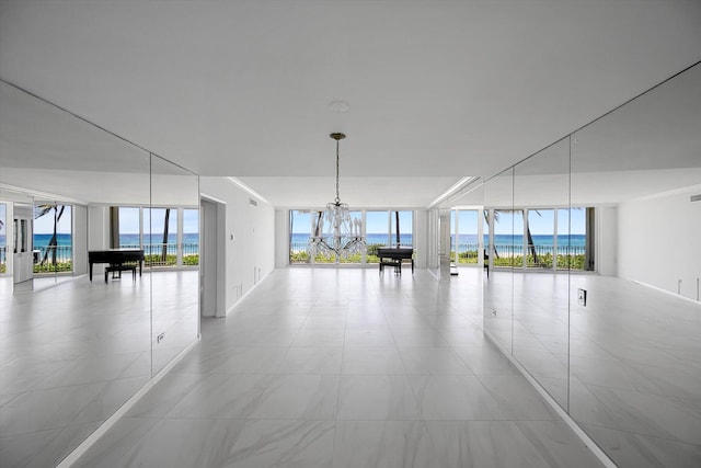 interior space with a water view, a healthy amount of sunlight, and a wall of windows