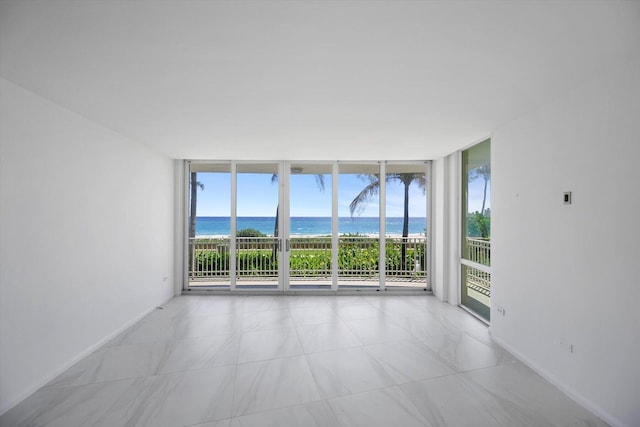 empty room with floor to ceiling windows and a water view