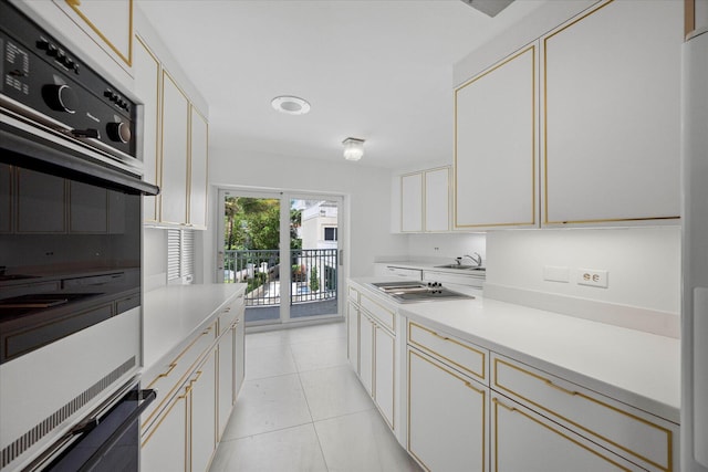 kitchen with double oven, sink, cooktop, and light tile patterned floors