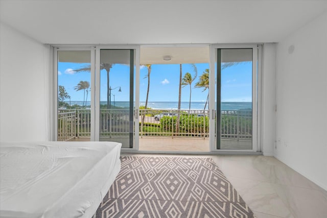 bedroom featuring a water view and access to outside