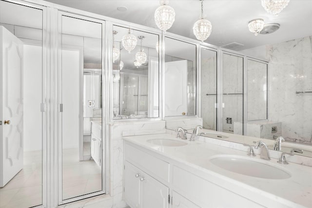 bathroom featuring vanity, walk in shower, and an inviting chandelier