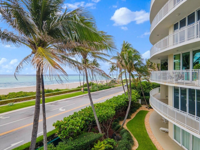 surrounding community featuring a view of the beach and a water view