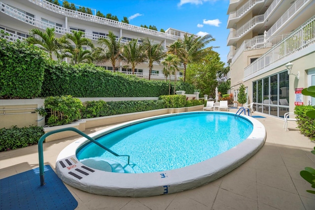 view of swimming pool with a patio area