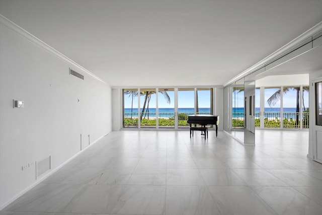 interior space with expansive windows, crown molding, a water view, and plenty of natural light