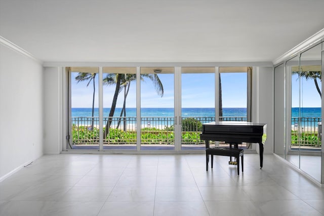 interior space with crown molding, a water view, and floor to ceiling windows