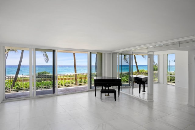 sunroom / solarium featuring a water view and plenty of natural light