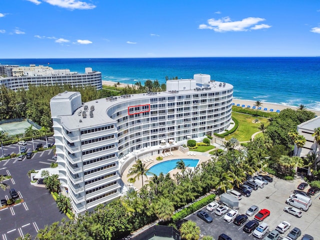 bird's eye view with a water view and a beach view