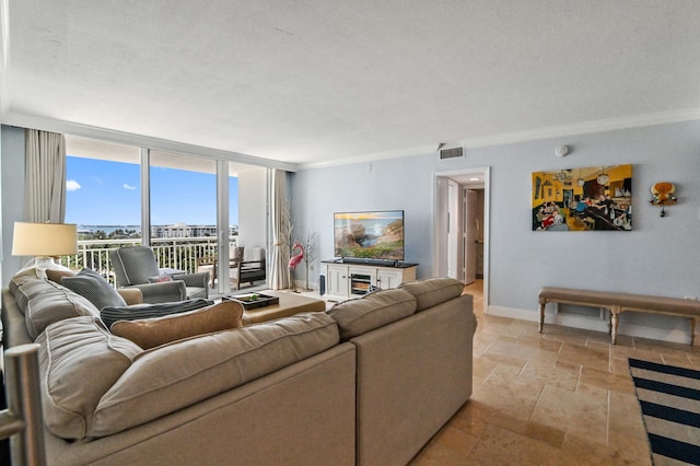 living room featuring expansive windows and a textured ceiling