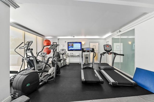 exercise room featuring ornamental molding