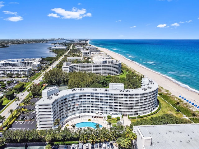 aerial view with a water view and a beach view