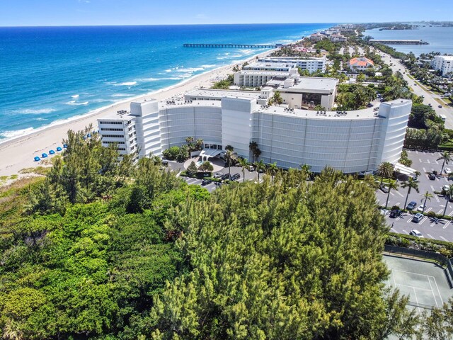 birds eye view of property with a view of the beach and a water view