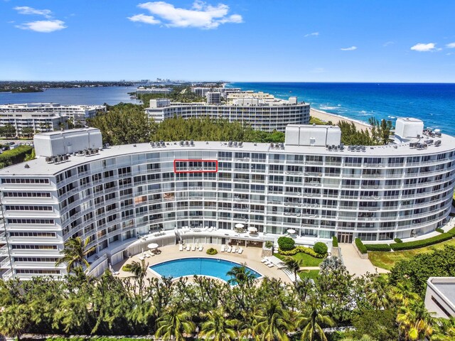 drone / aerial view with a water view and a beach view