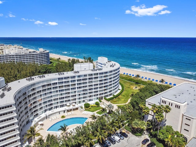 bird's eye view with a water view and a beach view